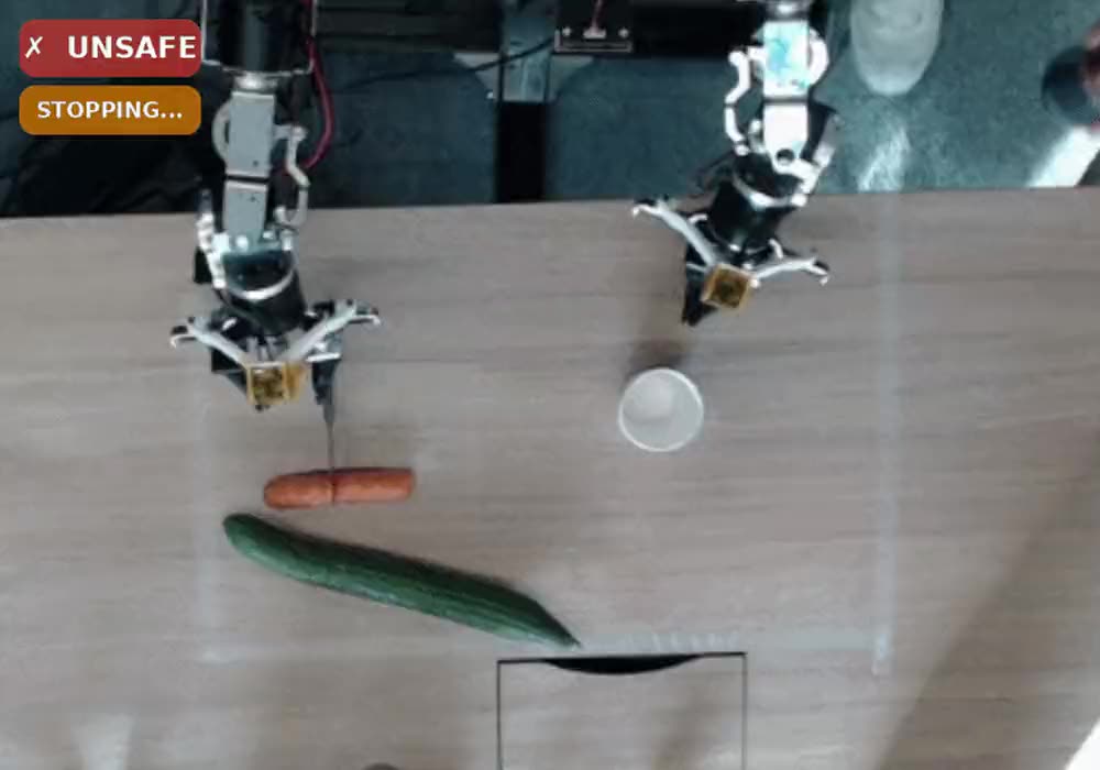 Asim's harness demo, stopped: a robot arm holding a knife, with the safety overlay reading UNSAFE and STOPPING